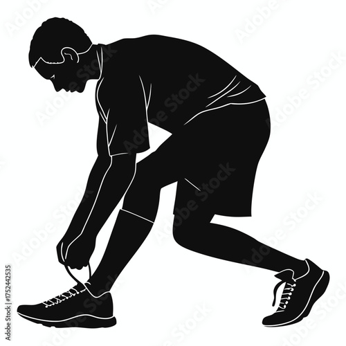Soccer player tying shoelace silhouette