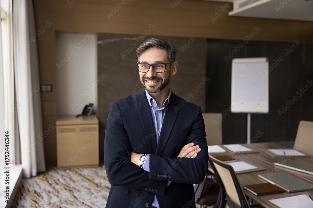 Fototapeta premium Portrait happy confident millennial businessman in formal suit at boardroom