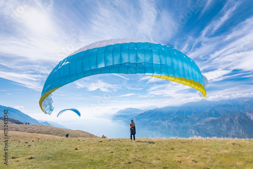 A paraglider preparing for the flight on the Monte Baldo mountain, on the Garda lake, Italy