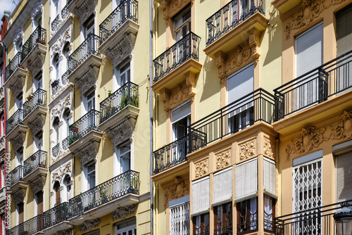 Vászonkép Detail of traditional yellow and white apartment building facades with wrought i