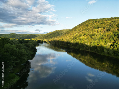 A drone shot of the sky reflecting off of the Allegheny River in Warren County, Pennsylvania, USA on a sunny summer day