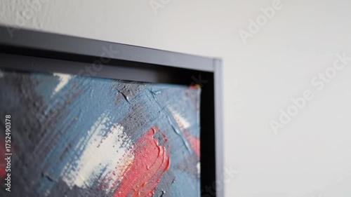 Close up of framed abstract painting with visible brush strokes
