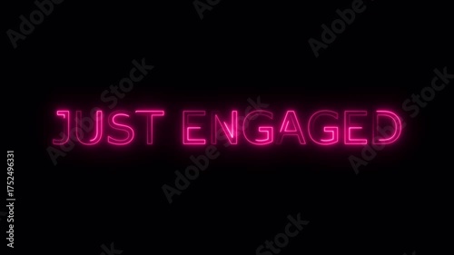 Just engaged text in vibrant pink neon against a dark background perfect for engagement announcements.