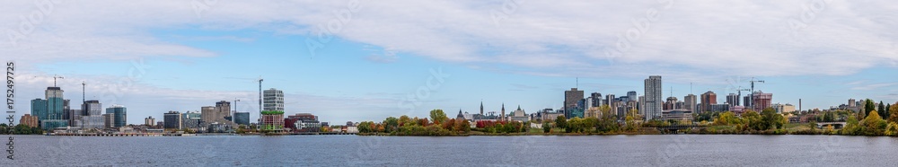 Fototapeta premium Wide high resolution panoramic view of downtown Ottawa, Ontario, and Gatineau, Quebec, across the Ottawa River and colorful autumn trees capture Canada’s National Capital Region (October 2025)