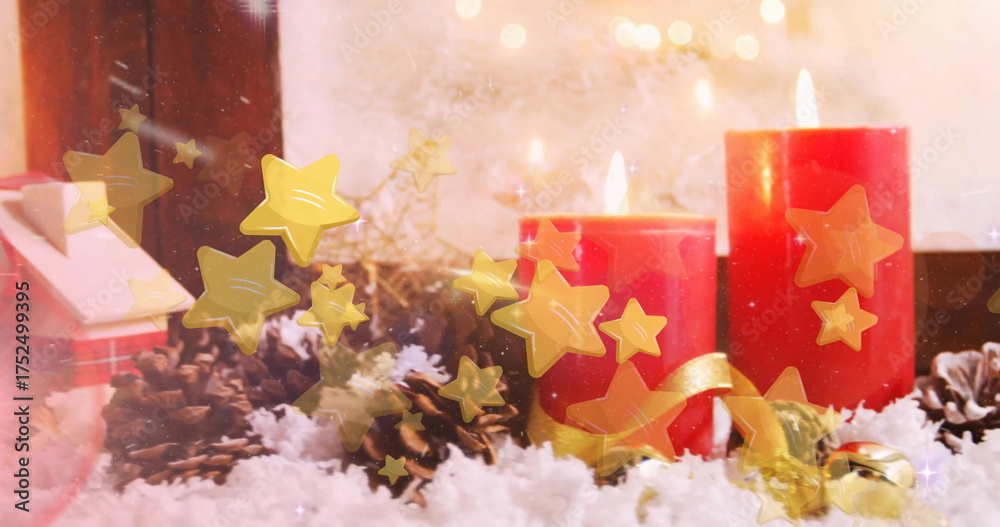 Fototapeta premium Image of stars floating over christmas decorations
