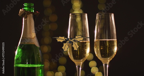 Image of christmas decorations ove champagne glasses and bottle on black background