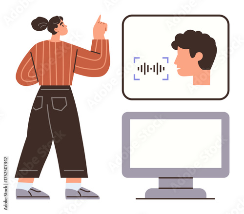 Woman pointing at a digital interface with speech recognition while standing near a computer monitor. Ideal for technology, AI, remote work, innovation, voice tech, communication, user interaction