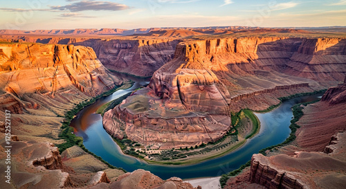 Breathtaking aerial view of horseshoe bend at sunset, capturing the golden light illuminating the colorado river and the surrounding canyon landscape in arizona