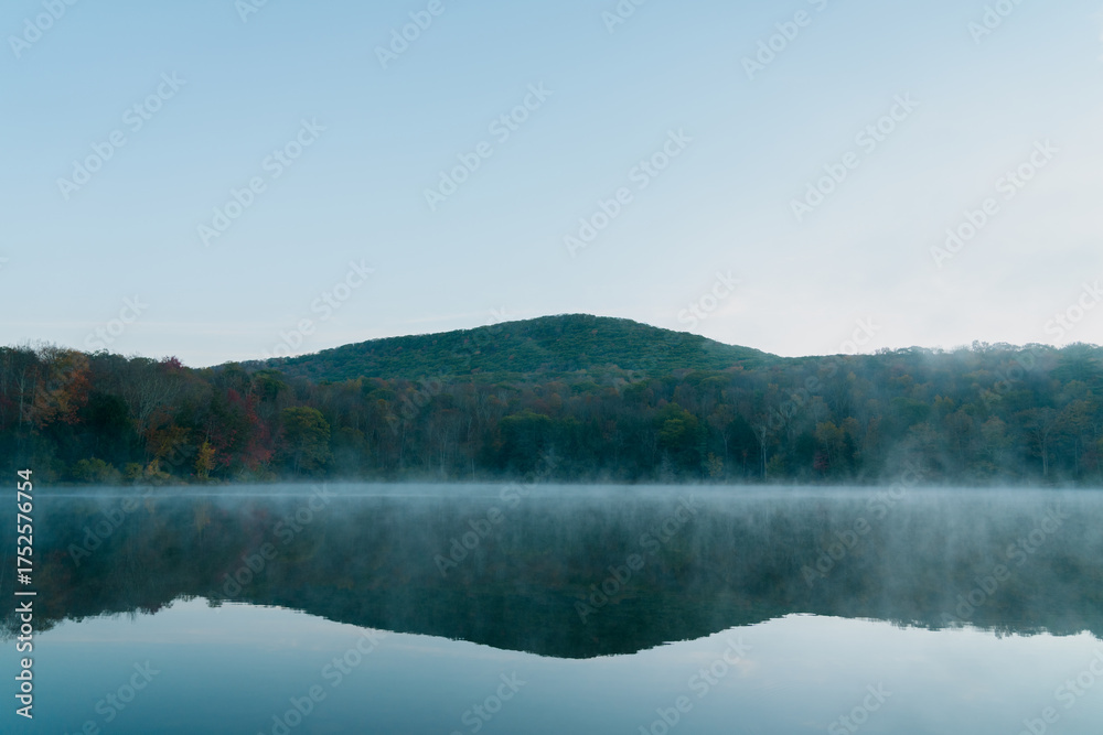Fototapeta premium Beautiful Autumn Forest with Mountain Fog and A Lake