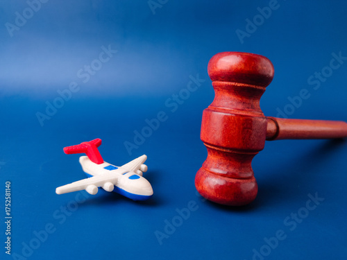 The image, which features a toy airplane next to a judge's gavel, is a visual representation of aviation law