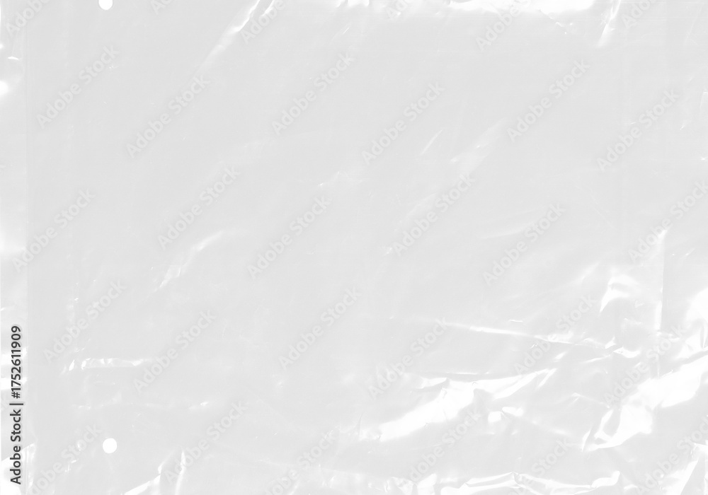 Obraz premium plastic transparent cellophane bag on white background. The texture looks blank and shiny. The plastic surface is wrinkly and tattered making abstract pattern
