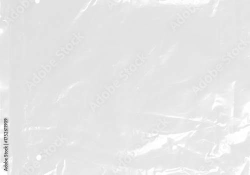 plastic transparent cellophane bag on white background. The texture looks blank and shiny. The plastic surface is wrinkly and tattered making abstract pattern