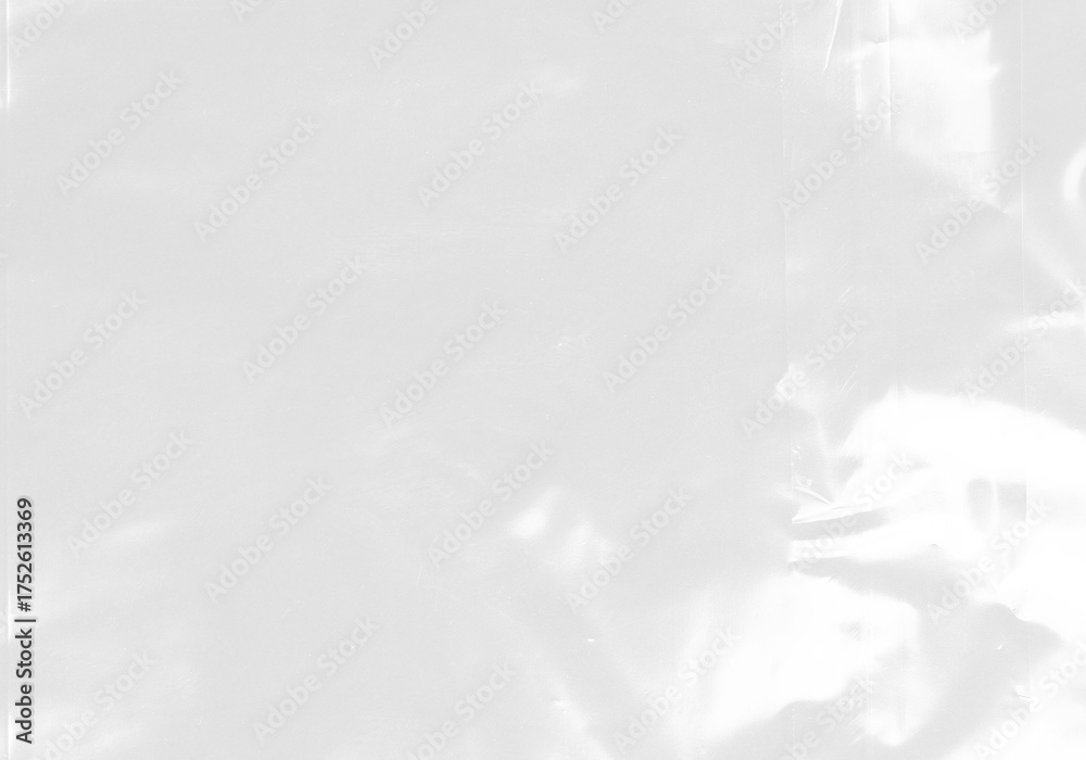 Obraz premium plastic transparent cellophane bag on white background. The texture looks blank and shiny. The plastic surface is wrinkly and tattered making abstract pattern