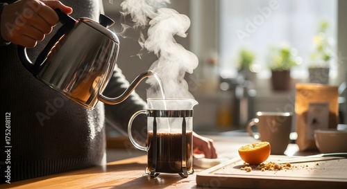 Pouring Hot Water into French Press for Coffee Preparation with Orange Slice