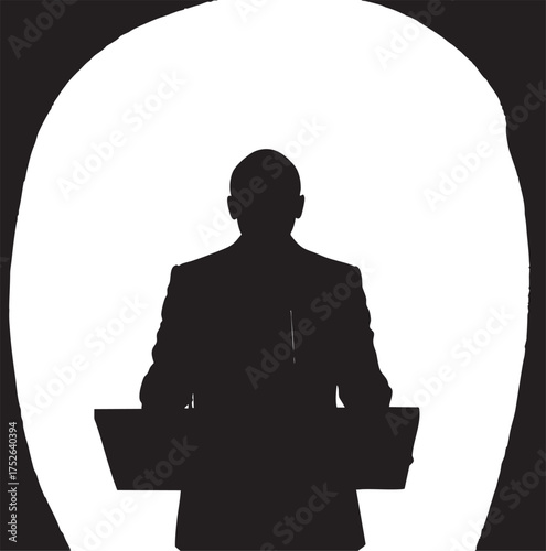 Silhouette of a man in a suit standing behind a podium with microphones against a bright background