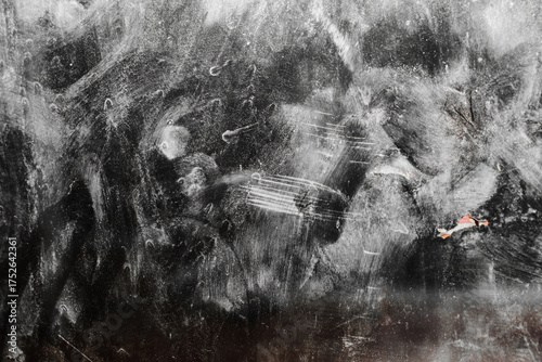 Background on dirty and dusty frosted glass. Dull frosted glass surface with dirty stains and spots.