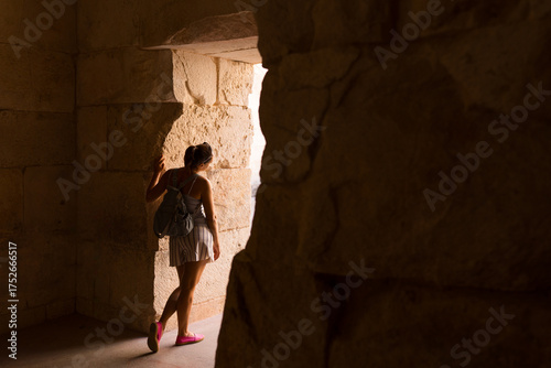 Woman exploring at Diocletian's Palace basements in Split discovering new paths