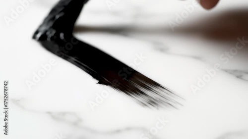 Applying Black Paint With Paintbrush on White Surface, Close Up