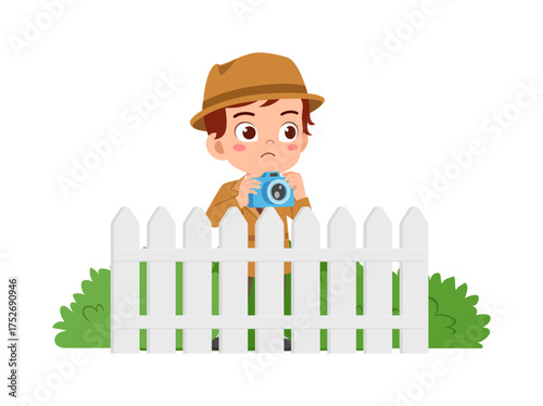Little Boy with Hat Taking Photo Behind Fence with Camera Looking Sad Wearing Jacket