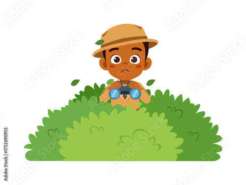 African boy using binoculars peeking from behind bush with curious expression
