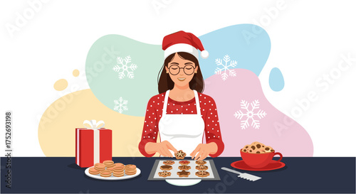A woman wearing a Santa hat and apron bakes Christmas cookies, arranging them on a baking sheet with festive decorations and a gift.