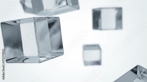 Close-up of multiple transparent ice cubes floating against a light background.