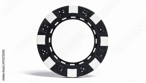 Describe a black and white poker chip with alternating edge segments featuring dice-like dot patterns. Highlight its blank white center and classic design for casino or gaming-themed visuals.
