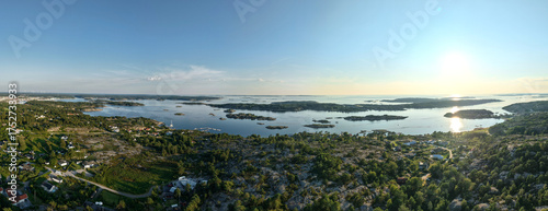 Panoramic Aerial View of Coastal Archipelago Near Strömstad, Sweden with Forested Terrain, Scattered Islands, and Sunlight Reflecting on Calm Sea