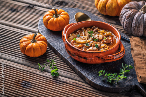 Фотография Warm stew with meat, cabbage and pumpkin, comfort autumn dinner balanced food