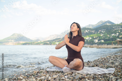 Meditation and yoga on beach woman with sea view promoting health balance and mindfulness in nature