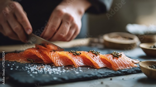 Chef Skillfully Slicing Smoked Salmon on Slate Board