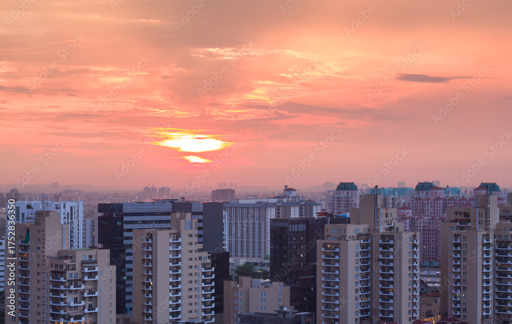 Obraz premium Aerail View of Gurgaon,Haryana,India at sunset.Gurugram city skyline with urban,modern architecture,design. Luxury residential apartments,commercial buildings of HNI in Delhi NCR.