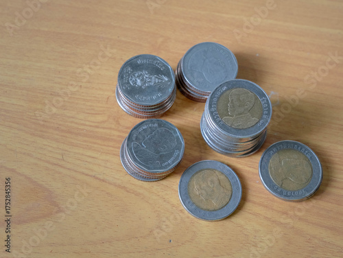 Coins or Thai Baht coins, close-up rows of money coins on desk 