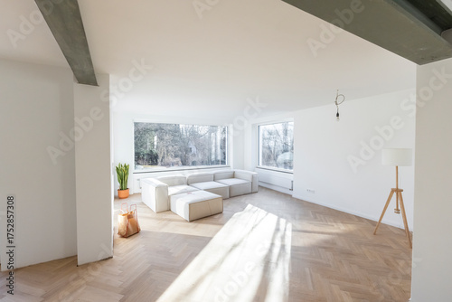 Minimalist living room under construction with lots of sunlight.