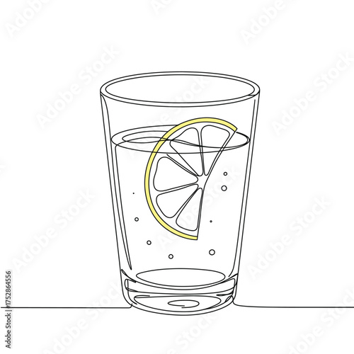 A refreshing glass of water with a lemon slice and bubbles.
