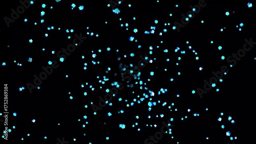 Blue glow glittering particles explosion effect on black background, holiday happy new year
