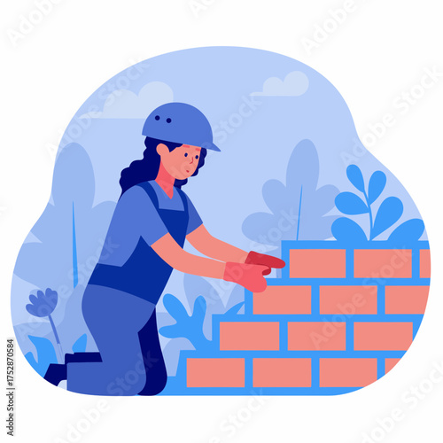 Young woman bricklayer constructing a wall in a garden environment - Concept of construction, repair  