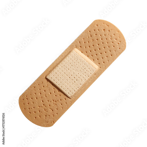Adhesive bandage, beige with a tan pad, diagonally against a black background, well lit