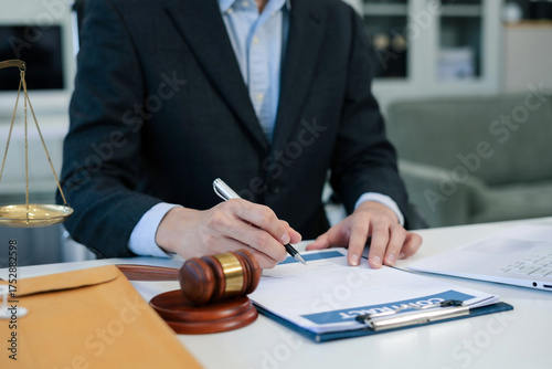 Lawyer working on a monograph in courtroom.