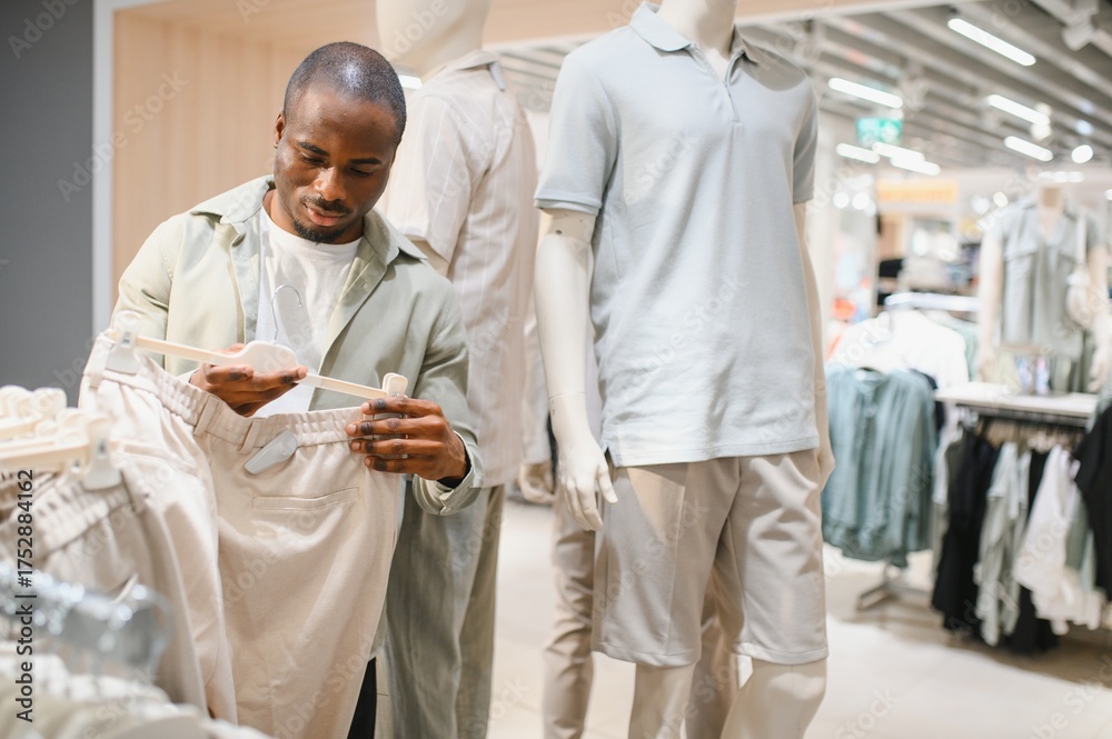 Fototapeta premium Man shopping for stylish clothes in mall
