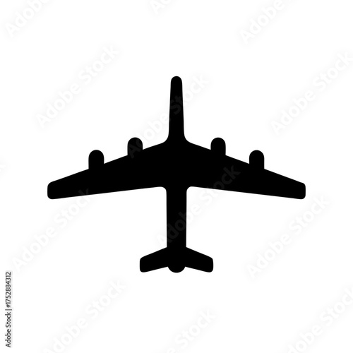 Silhouette of a large jet aircraft with four engines viewed from below showing its landing gear deployed for landing