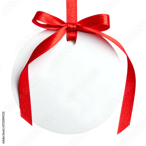A blank, white circular tag hangs by a red ribbon and bow against a transparent background