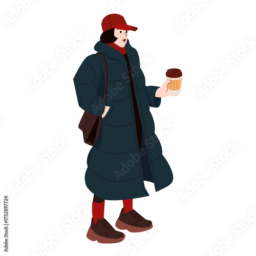 Woman in long puffer coat holding coffee cup wearing red cap and winter outfit standing isolated on white background