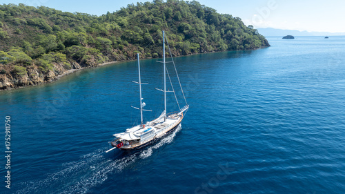 Wallpaper Mural A relaxing moment at sea as a traditional boat sails through the blue coastline. Torontodigital.ca