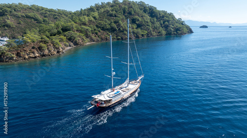 Wallpaper Mural A relaxing moment at sea as a traditional boat sails through the blue coastline. Torontodigital.ca