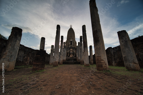 A large building with pillars and a statue of a man
