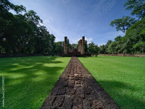 A path made of stone and grass leads to the ancient site.