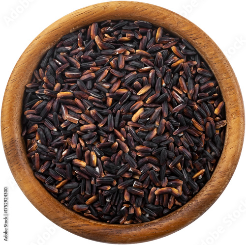 Black rice in wooden bowl isolated, top view