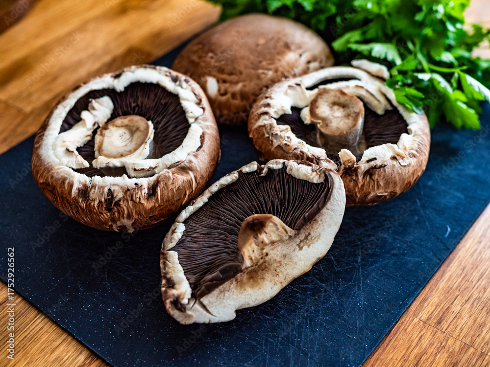Fototapeta premium Raw portobello mushrooms on wooden table