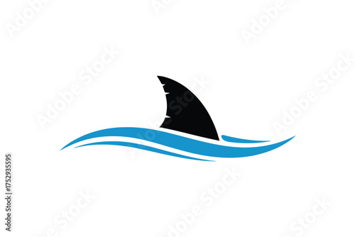 Shark fin emerging from blue ocean waves